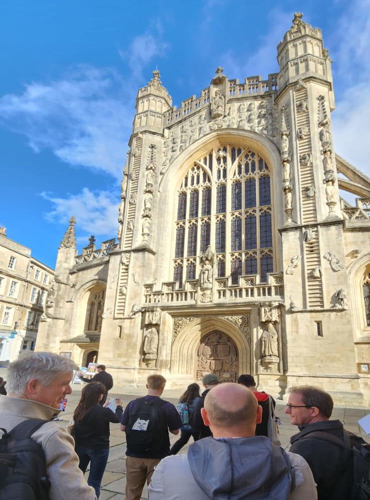 MSc students examining and sketching historic stonework at Bath Abbey during a field visit